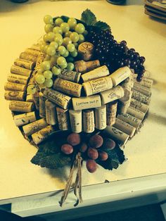 a bunch of wine corks sitting on top of a table next to some grapes