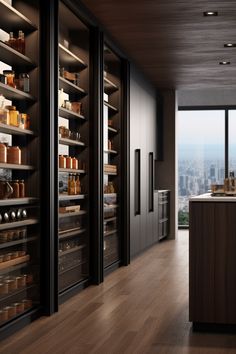 an empty kitchen with lots of shelves and cupboards in front of large windows overlooking the city