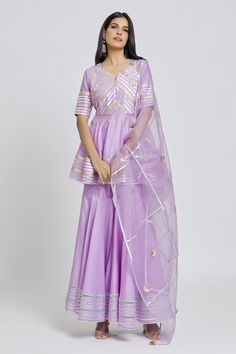 Purple peplum kurta with gota embroidery in striped pattern. Paired with a gharara and dupatta.
Components: 3
Pattern: Embroidered
Type Of Work: Gota
Neckline: Round V
Sleeve Type: Elbow
Fabric: Kurta and Gharara: Silk Chanderi, Dupatta: Organza
Color: Purple
Other Details: 
Gota striped embroidery
Occasion: Mehendi and Haldi - Aza Fashions Anarkali Style Organza Sharara With Peplum, Peplum Lehenga With Zari Work, Festive Peplum Lehenga In Organza, Festive Organza Lehenga With Peplum Shape, Festive Organza Peplum Sharara, Organza Sharara With Peplum For Festive Occasions, Organza Peplum Sharara For Festive Occasion, Peplum Organza Sharara For Festive Occasions, Festive Peplum Lehenga With Sheer Dupatta