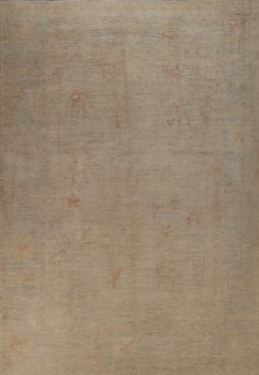 an old rug with faded edges and no pattern on the top, in neutral tones