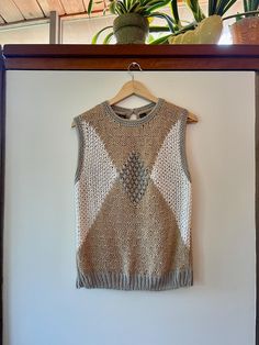 Gorgeous vintage 80s hand knit textured sleeveless sweater.  Made of 55% ramie and 45% acrylic. Love the neutral color combo. By BRAMBLE LANE. Size M. WE In good vintage condition. Showing light signs of normal age and wear.  Measurements taken while item was laying flat.  Bust: 18.5" Length: 24.5" Beige Textured Knit Sweater Vest For Layering, Vintage Knitted Beige Tops, Vintage Beige Tops For Layering, Beige Vintage Tops For Layering, Vintage Beige Knitted Tops, Retro Beige Knit Sweater, Retro Beige Knit Tops, Hand Knitted Cream Knit Tops, Beige Hand Knitted Tops