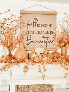 a fireplace mantel decorated with fall foliage and pumpkins