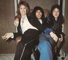 three young men sitting in a chair together