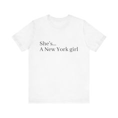 a white t - shirt that says she's a new york girl