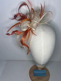 Orange & cream high-quality sinamay bow attached to coordinating headbands for easy wear. Each fascinator is crafted by hand, ensuring that no two pieces are exactly alike. Our bow design fascinators are available in a variety of colors to match any outfit. Whether you're looking for a bold pop of color or a subtle neutral tone. 🖤This head piece looks simply stunning and is perfect for weddings, special occasions or a day at the races.  🖤All head pieces are finished with matching headband wrapped in co-ordinating silk ribbon or secure millinery elastic which is comfortable and easy hidden. 🖤Shipped in a sturdy (keepsake) box and packed with special love and care.  🖤Made in the UK - customised fascinator orders are welcome. Please send me a message and we can create something unique.  T Adjustable Ribbon Headpiece For Wedding, Elegant Ribbon Headband For Wedding, Adjustable Bow Hair Accessories For Wedding, White Bow Headband For Wedding, White Adjustable Bow For Wedding, Adjustable Wedding Fascinator With Satin Bow, Adjustable White Bow For Wedding, Adjustable Wedding Hair Accessories With Decorative Bow, White Wedding Headband With Decorative Bow