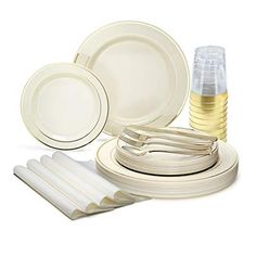 white dinnerware set with gold trimmings and place settings on a white background