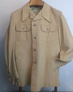 "✰ Vintage 1970s HUDSON'S MEN'S STORE Lined Suede Jacket ✰ Suave and suede! ✰ Soft, stylish and timeless! Circa: 1970s Material: Suede  Lining: Nylon Label: Hudson's Men's Warehouse Made In: Not Labeled (Korea or Hong Kong possibly. Common for this era of clothing) - MEASUREMENTS- (measurements taken flat) please refer to listing images for how we measure Label size: Not Labeled, but M by measures. Please compare to an item you wear regularly.  Length: 30\" Shoulder: 19\" Chest: 23\" Hem: 24.5\" Vintage Khaki Outerwear With Lapel Collar, Vintage Fitted Khaki Outerwear, Fitted Vintage Khaki Outerwear, Fitted Khaki Vintage Outerwear, Vintage Beige Outerwear With Flap Pockets, 1970s Style Fall Outerwear With Pockets, Vintage Beige Outerwear With Snap Buttons, 1970s Vintage Long Sleeve Outerwear, 1970s Long Sleeve Vintage Outerwear