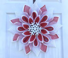 This Winter Snowflake Wreath in red and white with flocked wooded snowflake center for your front door holiday decor on thru the winter months would also be a great gift wreath. The wreath may be displayed on your front door, porch or indoors. I have sprayed with a UV protectant spray to reduce raveling and fading however I recommend displaying under a covered stoop or porch to lengthen the life of your wreath. This is made on a recycled plastic wreath board. Follow this link for more Christmas items: https://www.etsy.com/shop/MemawsCottage?ref=seller-platform-mcnav&section_id=30402647 PLEASE NOTE SHIPPING TIMES CAREFULLY AS THEY CHANGE FROM TIME TO TIME DUE TO PERSONAL CIRCUMSTANCES. Wreath With Garland, Red White Christmas Wreath, Christmas Flower Wreaths, Christmas Deco Mesh Wreaths, Couronne Diy, Gift Wreath, Snowflake Wreath, White Christmas Wreath, Front Door Christmas Decorations