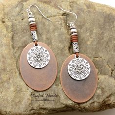 Introducing these stunning Mixed Metal Boho Leather Dangle Earrings - the perfect blend of rustic charm and contemporary style! These captivating earrings are meticulously handcrafted to infuse a touch of bohemian allure into your everyday or special occasion ensemble. **Materials Our mixed metal boho earrings feature a harmonious fusion of copper and silver tones, creating a dynamic contrast that's both eye-catching and versatile. The warm, earthy hues of copper beautifully complement the cool, Brown Artisan Metal Earrings, Artisan Brown Metal Earrings, Rustic Brown Brass Earrings, Brown Dangle Metal Earrings, Brown Metal Dangle Earrings, Earthy Metal Dangle Earrings, Rustic Brass Drop Earrings, Nickel-free Rust Drop Earrings, Vintage Rust-colored Nickel-free Earrings