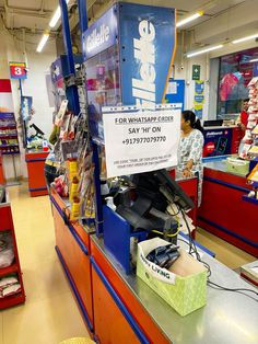 a woman standing in front of a sign that reads for what's up at the store