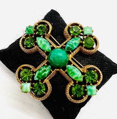 Gorgeous Large Vintage signed CAPRI Peking Glass & Rhinestone Maltese Cross Brooch. Antiqued gold plated metal set with Peking Glass stones as well as green rhinestones. In excellent vintage condition with minimal age appropriate wear. No chips or cracks. Measures 2 7/8 inches tall and wide. Roll over clasp secure. Victorian Green Collectible Brooches, Antique Green Jeweled Jewelry, Vintage Green Brooch Jewelry, Vintage Green Jeweled Jewelry, Green Jeweled Brooch Gift, Green Jeweled Brooches For Gifts, Green Jeweled Brooches As Gift, Green Jeweled Brooch For Gift, Elegant Green Jeweled Brooches