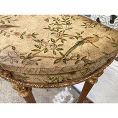 an ornately decorated stool with birds and flowers painted on the seat is shown in this image