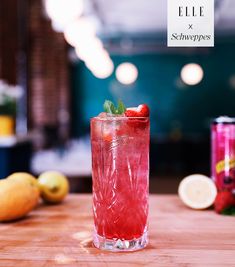 a red drink sitting on top of a wooden table