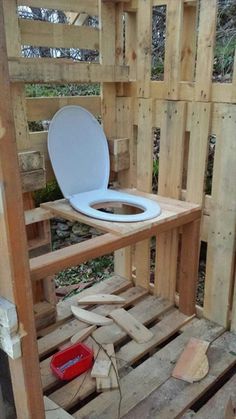 a toilet sitting on top of wooden pallets