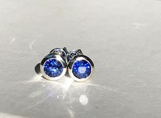 Looking for a pair of sparkling blue sapphire earrings? This pair of natural ceylon blue sapphire stud earrings is a perfect match. These earrings are made with 14k solid white gold, bezel front, screw backing style feature 2 round natural ceylon deep blue sapphires (approx 1.00ct weight, Vs clarity, heated Bezel front diameter is approx 6mm total  **All our products will come with a certificate of authenticity provided by The Valuation Centre of Australia who are GIA graduates, senior gemologis Ethical Sapphire White Gold Earrings, Blue Bezel Set Earrings For Formal Occasions, White Gold Sapphire Birthstone Earrings, Blue Bezel Set Earrings For Gift, Pink Diamond Earrings, Blue Sapphire Earrings, Sapphire Stud Earrings, Blue Sapphire Studs, Ceylon Blue Sapphire