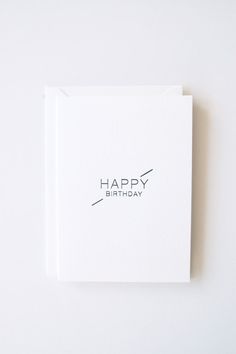 a white card with the words happy birthday on it and a black line across the front