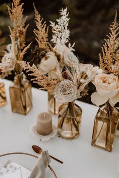 there are flowers in vases on the table