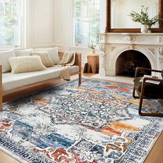 a living room filled with furniture and a large rug on top of a hard wood floor