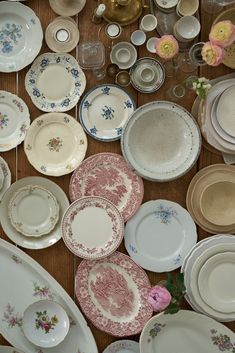 a table topped with lots of different types of plates and bowls next to each other