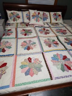 a quilted bedspread with many different designs on the sheets and pillow cases