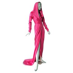 Elsa Schiaparelli's iconic "Shocking Pink" evening dress. Fully fashioned in silk charmeuse with attached hood and cross-over waist closure. Slender sleeves with zipper wrists. Full dramatic train enhances the look. Fantastic fashion flair in this deco inspired 2021 gown. This collection boasts exciting and dramatic entrance pieces. Definitely a standout piece. Size: 40; bust: to 34"; waist: approx 25"; hips: approx 38"; length: approx: 66" Condition: brand new; excellent Hood Dress, Rosa Shocking, Pink Evening Dress, Elsa Schiaparelli, Shocking Pink, Fully Fashioned, Dress Gown, Moda Vintage, Silk Charmeuse