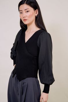 Our black contrast satin sleeved top brings glamour and comfort together. The luxurious satin balloon sleeves add elegance while the ribbed bodice offers the most flattering fit. Carefully designed the hem of this top matches the V-neck for an effortlessly chic look. - Satin balloon sleeves - Black V-neck top - Long sleeve - Cross panel top Elegant V-neck Tops With Sheer Sleeves, Black V-neck Puff Sleeve Top For Fall, Elegant Stretch V-neck Top For Fall, Black V-neck Top For Workwear In Fall, Black V-neck Top For Fall Workwear, Fall V-neck Top With Sheer Sleeves, Chic Black V-neck Puff Sleeve Top, Black V-neck Tops With Sheer Sleeves, Fitted V-neck Top With Pleated Sleeves