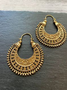 Stunning Tribal Hoop Earrings, a perfect blend of contemporary fashion and ethnic charm. Handcrafted with precision and passion, these earrings are designed to make a statement. 🌟 Key Features: - Unique tribal-inspired design - Handcrafted with sturdy high quality brass for durability  - Versatile, ideal for casual or dressy occasions - Skillfully crafted for a touch of authenticity ✨ Product Details: Embrace the allure of tribal aesthetics with these hoop earrings. Their distinctive design captures the essence of tradition and modernity, making them a must-have accessory for your collection. 🎁 Perfect Gift: Whether treating yourself or surprising a loved one, these tribal hoop earrings make a thoughtful and stylish gift. Perfect for birthdays, celebrations, or just because. ⚡️ Keywords: Soft Accessories, Indian Brass, Ethnic Style, Brass Jewelry, Earrings Boho, Stylish Gifts, Ethnic Fashion, Contemporary Fashion, Boho Earrings