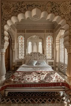 an ornate bed in the middle of a room with white walls and arches on either side