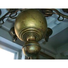 an old fashioned light fixture hanging from the ceiling