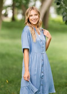 The Brenna Chambray Tiered Shirt Midi Dress is the perfect dress to wear to go on a walk, enjoy a cup of coffee at a park or grab brunch with your friends! The chambray style and button-down design offer a chic and trendy look, while the sleeves land at the elbows for a laid back style! Pair with sneakers, sandals, wedges, or booties for a look that is as unique as you! Style | Short Sleeve, Midi Color | Blue SIZING TIPS Fit | Loose Fit Stretch | None Model | True to Size Shirt Midi Dress, Sandals Wedges, Professional Wardrobe, School Dresses, Church Dresses, A Cup Of Coffee, Midi Shirt Dress, A Park, Laid Back Style