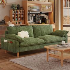 a living room filled with furniture and bookshelves next to a wooden coffee table