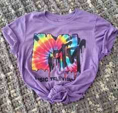 I am an 80's baby and I LOVED MTV when it was truly music television. Here's to honoring our beloved TRL and morning music videos while getting ready for school. Please note that ALL shirts are made to order- allow a minimum of seven (7) days for delivery. If you want expedited processing and shipping (only available for US orders), it will be an additional $20, but contact me ahead of time to arrange. This classic unisex jersey short sleeve tee by Bella & Canvas fits like a well-loved favorite. Mtv Tshirt, Mtv Shirt, Getting Ready For School, Mtv Logo, Morning Music, 80s Shirts, 90s Hip Hop Fashion, Ready For School, 90s Shirts