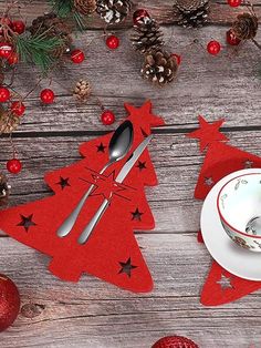 red christmas tree placemats with silverware on wooden table