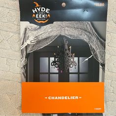 an advertisement for a chandelier hanging on the wall in front of a door