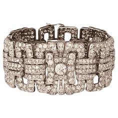 An Art Deco diamond bracelet. Set throughout with brilliant and circular-cut diamonds. The largest diamonds estimated to weigh 1ct each. Total diamond weight approximately 25cts. French marks. Circa 1935. 19cm in length and approximately 3.1cm wide. 99 grams. Set in platinum. Numbered "228" and with French marks. Price: 51,350£. Item is in very good condition without any damage. Return policy within 3 days is applied. Please make sure you watch the short video that gives real and accurate perspective of the item. French Art Deco, Art Deco Diamond, Antique Diamond, Van Cleef Arpels, Vintage Designer, French Art, Diamond Gemstone, Short Video, Link Bracelets