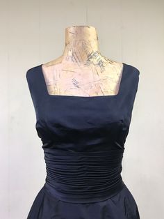 "* Designer wiggle dress c 1960s * Black silk peau de soie fabric * Fitted empire bodice with square, open neckline and flap in back * Pleated, 5\" wide cummerbund waistband * Pencil skirt has 4\" center back kick-pleat * Giant bow detail below waistband has long tails hang 4\" below hem * Center back metal zipper closure * Unlined Label: Ruth McCulloch - Evanston - Hubbard Woods Here are some interesting facts about Ruth McCulloch: https://artsandculture.google.com/exhibit/RQLif2S-VZjsJA Excell Fitted Sleeveless Dress With Pleated Bodice For Cocktail, Fitted Sleeveless Dress With Pleated Bodice For Evening, Fitted Silk Sleeveless Dress For Formal Occasions, Formal Fitted Sleeveless Dress With Lined Bodice, Fitted Silk Sleeveless Evening Dress, Classic Silk Sleeveless Dress, Classic Sleeveless Silk Dress, 1950s Style Sleeveless Cocktail Dress, Fitted Sleeveless Dress With Ruched Bodice For Evening