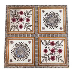 four square tiles with floral designs on them