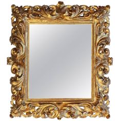 an ornate gold framed mirror against a white background