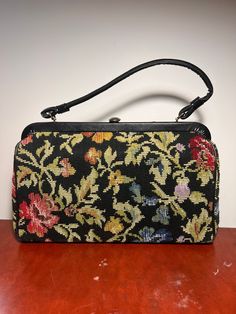 "Circa 1970s kadin neddlepoint handbag with single handle. Interior pocket. Has wear consistent with age. Lining in good condition.  13\" wide 13\" tall with handle" Formal Handheld Briefcase With Detachable Handle, Travel Handheld Satchel With Single Handle, Vintage Style Double Handle Shoulder Bag For Travel, Vintage Shoulder Bag With Detachable Handle For Everyday, Evening Rectangular Satchel With Adjustable Handle, Formal Rectangular Satchel With Adjustable Handle, Evening Rectangular Briefcase, Formal Handheld Briefcase With Top Carry Handle, Vintage Black Shoulder Bag With Double Handle