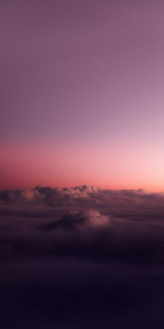 the sky is filled with clouds as the sun goes down in the distance behind it