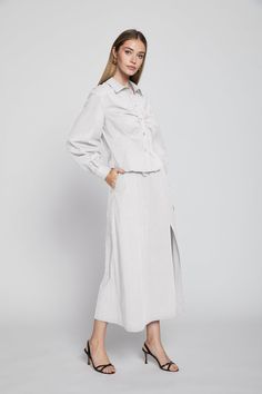 Cotton poplin ruched front long sleeve blouse with button closures. Spring Long Sleeve Ruched Blouse, Spring Ruched Long Sleeve Blouse, Spring Ruched Blouse, Workwear Button-up Blouse With Gathered Sleeves, Chic Ruched Cotton Blouse, Long Sleeve Ruched Tops For Workwear, Ruched Long Sleeve Workwear Top, Button-up Blouse With Gathered Sleeves For Work, Long Sleeve Ruched Blouse For Fall