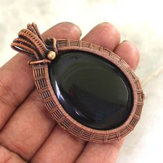 Welcome to our little shop, where you can find handmade copper wire jewelry and more, for you and your loved ones. We do accept custom orders also, kindly message us for more. Tree of Life Black Onyx Gemstone Copper Wire Wrapped Handmade Pendant Gemstone : Black Onyx Pendant length : 70 MM Pendant Width  :-45 MM Metal : Copper Why To Wear Black Onyx : Imparts self-confidence, helping you to be at ease in your surroundings. Onyx banishes grief, enhances self-control and stimulates the power of wi Handmade Black Copper Wire Jewelry, Hand Wrapped Black Copper Jewelry, Handmade Brown Jewelry For Gift Making, Black Round Copper Jewelry, Black Copper Round Jewelry, Handmade Black Jewelry For Gift Making, Black Onyx Pendant, Copper Wire Jewelry, Copper Jewelry Handmade