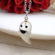 "This Ghost Charm necklace comes on a silver-plated chain that is available in different lengths. Please choose your desired length from the drop-down menu when placing the item in your shopping cart. { CHARM DETAILS } ★ Material: Resin ★ Finish Color: White ★ Measurements: 3/8\" x 3/4\" ★ Dimensions: 3-Dimensional { SIMILAR ITEMS } More Halloween themed items available from my shop: https://www.etsy.com/shop/treasuredcharms/search?search_query=halloween { GIFT OPTIONS} Gift boxes are available at no additional cost and can be added from the drop-down menu during checkout.   You can mark it as a gift, add a gift message, and send it directly to a recipient by entering their address in the 'shipping address' during checkout.  Receipts with price information are not included with orders that White Gothic Necklace Gift, Spooky Halloween Jewelry For Costume Party, Novelty Halloween Party Necklaces, Spooky White Halloween Jewelry, Spooky Halloween Costume Party Jewelry, Halloween Silver Charm Jewelry, Halloween Novelty Necklaces As Gift, Silver Halloween Charms Jewelry, Halloween Themed Silver Necklaces