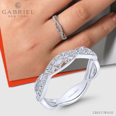 A flawless mixture of filigree detailing and magnificent .23ct pave diamonds create this one of a kind stackable ring. The contoured silhouette is crafted from polished 14k white gold for timeless elegance. LR6317W45JJ #FineJewelry#FashionJewelry#UniqueJewelry#GiftIdeas#UniqueGifts #DiamondJewelry #Jewelry #Mother'sDay#Ladies'Ring#DiamondStackable Elegant Stackable Wide Band Ring For Wedding, Modern Twist Open Band Diamond Ring, Designer Wedding Rings With Diamond Accents, Elegant Wide Band Ring With Diamond Accents For Wedding, Elegant Wide Band Ring For Wedding, Elegant Wide Band Wedding Ring With Diamond Accents, Elegant White Wide Band Promise Ring, Modern Stackable Rings In Diamond White, Engraved Wide Band Ring For Anniversary