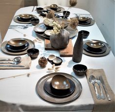 a table set with plates and silverware