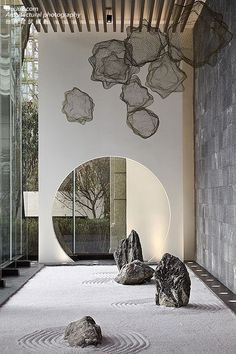 a room with some rocks in the middle and a mirror on the wall next to it