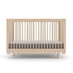 a small wooden crib with grey sheets on the bottom and sides, in front of a white background