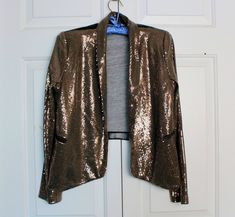 "Vintage Sequin Jacket, Handmade Fabric and Faux Leather Blazer Wear, Stretch Easy Wear, Not Lined, Styled 90s Wear, Simple Club Dinner Dress Up Vintage open-front dress jacket, handmade. With front and sleeves adorned in tiny sequins dark brown fabric while the back is made of black polyvinyl.  The jacket features shoulder pads and front falls pockets.  Please note that due to its vintage nature, there may be some missing sequins. There are no refunds or exchanges, items are sold \"as is\" or \"all sales are final\", but it is my goal to provide 100% customer satisfaction, so if you have any questions about an item, please contact me. In accordance with my terms of business, I have specified that there are no refunds due to shipping delays or loss the parcel.  With you agreeing to purchas Winter Going Out Fitted Blazer, Winter Outerwear With Sequins, Vintage Sequin Jacket, 90s Wear, Faux Leather Blazer, Sequin Jacket, Club Dress, Dress Jacket, Vintage Nature