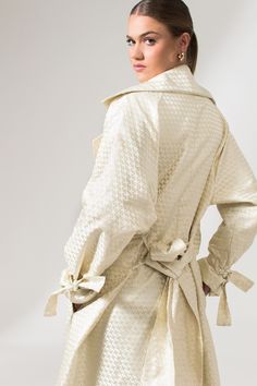 The Mae Trench Coat is a reinvented bold twist on the classic Mary Trench Coat. Crafted from pure jacquard silk, it is a double-breasted coat that comes in a relaxed fit with wide lapels, collar, and sleeves. It's elevated through its minimal interwoven matte-finished chequered pattern, fluid shape, and French seams. This sustainable trench coat is tailor made and on demand and takes us 10 hours to make it. PLEASE ALLOW 1-5 BUSINESS DAYS FOR PRODUCTION Chic Fall Jacquard Outerwear, Chic Jacquard Long Sleeve Outerwear, Chic Jacquard Outerwear For Fall, Chic Silk Outerwear For Daywear, Chic Silk Outerwear With Hidden Button Closure, Luxury Silk Double-breasted Outerwear, Luxury Silk Outerwear For Spring, Cream Silk Outerwear For Fall, Chic Silk Double-breasted Outerwear