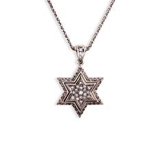 Behold this large, brilliant, two-layered, diamond-encrusted Star of David pendant in 14k white gold. Two beautiful diamond-paved Magen Davids are displayed in stunning relief. Fifty-nine diamonds adorn this layered Jewish star pendant, with a shiny raised gold border separating the inner and outer stars. And no design detail has been overlooked. The pendant clasp is adorned with a delicate strip of diamonds and the thick raised-edge contour and dotted surface of the backside bears a beautiful h David Star, Jewish Star, Gold Necklace Simple, Star Of David Pendant, Gold Border, High Relief, Diamond Star, Mid Size, Star Of David